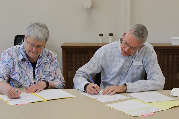(From left) Sister Patricia Hayden, Sisters of Charity president, and Jeff Ginter, president of the Western Wildlife Corridor Board of Trustees, sign the official paperwork to transfer 73 acres of property from the Sisters of Charity of Cincinnati to the Western Wildlife Corridor, Inc.